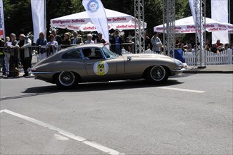 A grey Jaguar E-Type Coupe at a classic car race in front of an interested audience, SOLITUDE