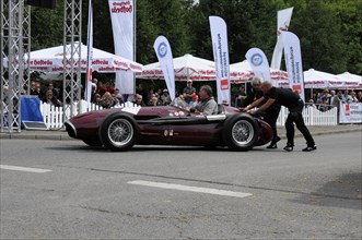 A classic racing car is pushed by people at the starting line of a car race, SOLITUDE REVIVAL 2011,