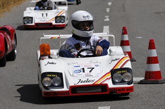 Racers in white miniature cars on a race track with spectator participation, SOLITUDE REVIVAL 2011,