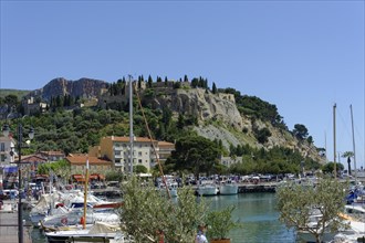 The bay of Port Miou in Cassis, A sunny harbour view with boats surrounded by steep cliffs and