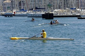 Marseille harbour, people rowing on the sea, an athlete in the foreground, Marseille, Departement