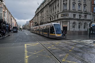 A Luas tram stops for passengers on a day of mixed weather. Dublin, Ireland, Europe