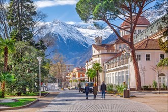 Spa promenade with spa centre in spring in front of the peak 3006m in the Texel Group, Merano, Val