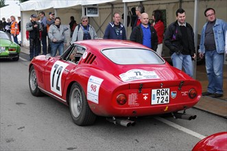 Red classic racing car with starting number 72, surrounded by spectators, SOLITUDE REVIVAL 2011,