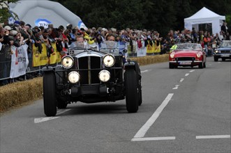 A vintage car with illuminated headlights at a classic car race, SOLITUDE REVIVAL 2011, Stuttgart,