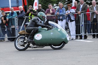 Racer on a sidecar motorbike in action in front of an audience along the race track, SOLITUDE