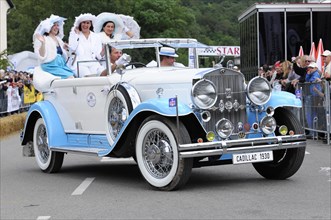 Cadillac Imperial Phaeton, built in 1930, A historic white Cadillac in a festive parade with