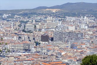 Marseille, Panoramic view of the city of Marseille with buildings and hills in the background,