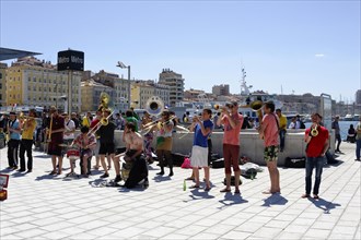 Marseille, Music group performs outdoors at the harbour, the audience listens, Marseille,
