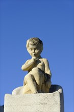 Church of Notre-Dame de la Garde, Marseille, statue of a pensive child in front of a clear blue