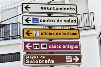 Several signposts with pictograms indicating different tourist destinations, Andalusia, Spain,