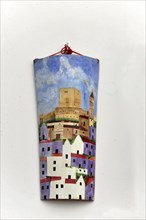 Solabrena, Colourful hanging painting of a city view on a white wall, Costa del Sol, Andalusia,