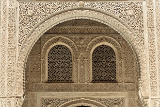 Artistic stone carvings, Alhambra, Granada, An intricately decorated window with arabesques in a
