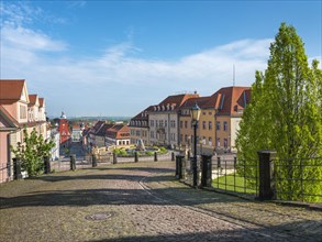 Cobbled street leading from Friedenstein Castle to the historic old town with the main market