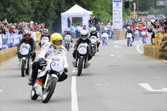 A group of motorcyclists during a race, surrounded by spectators, SOLITUDE REVIVAL 2011, Stuttgart,