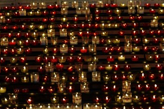 Church of Notre-Dame de la Garde with mosaics, Marseille, Many lit candles arranged in rows create