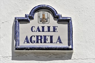 Solabrena, ceramic street sign with blue ornaments and heraldic coat of arms on a white wall, Costa