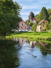Zechenstein rock formation and half-timbered houses on the Puettlach river, rock castle and
