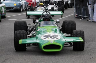 Front view of a green formula car on a race track with the driver at the wheel, SOLITUDE REVIVAL