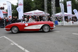 A red vintage sports car drives past spectators as a convertible, SOLITUDE REVIVAL 2011, Stuttgart,
