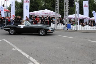 A black Jaguar E-Type classic car on the road with spectators in the background, SOLITUDE REVIVAL