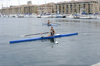 Marseille harbour, Two rowers in a rowing boat in a harbour area, Marseille, Departement