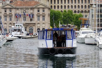 Marseille harbour, A small ferry with passengers crosses the harbour water, Marseille, Departement