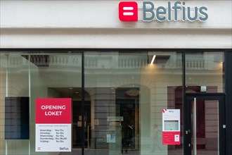 Office window showing opening hours of Belfius bank branch in the city Ghent, East Flanders,