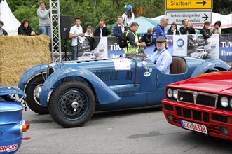 A blue classic racing car is admired by spectators at an event, SOLITUDE REVIVAL 2011, Stuttgart,