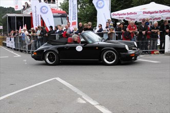 Black Porsche 911 from the side at an event with an audience, SOLITUDE REVIVAL 2011, Stuttgart,