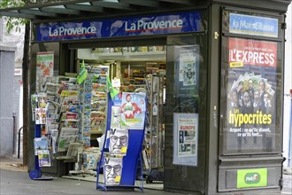 Marseille, A street kiosk with a variety of newspapers and magazines under a blue sign, Marseille,