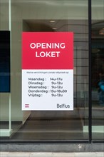 Office window showing opening hours of Belfius bank branch in the city Ghent, East Flanders,