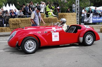A red vintage convertible with starting number 80 on a race track, SOLITUDE REVIVAL 2011,