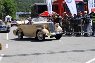 Gold-coloured classic car at a rally with spectators in the background, SOLITUDE REVIVAL 2011,