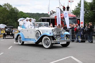 Cadillac Imperial Phaeton, built in 1930, A white and blue convertible vintage car drives past an