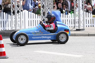 Driver in a blue racing soapbox skilfully manoeuvres on the race track, SOLITUDE REVIVAL 2011,