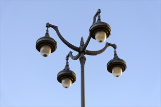 Historic-looking quadruple street lamp against a clear sky, Marseille, Departement