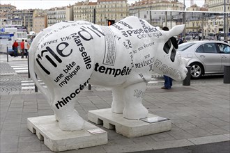 Marseille, A rhinoceros sculpture covered with headlines on a pavement in the city, Marseille,