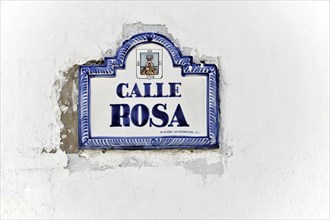 Solabrena, A white and blue ceramic sign on a wall shows 'Calle Rosa' as the street name,
