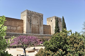 Alhambra, Granada, Andalusia, Historic fortress with two towers and tourists in the foreground