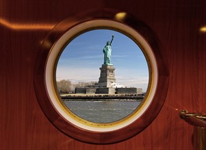 View of the Statue of Liberty through a ship's porthole