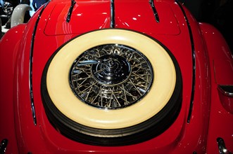 Detailed close-up of the wheel of a red vintage car, Mercedes-Benz Museum, Stuttgart,
