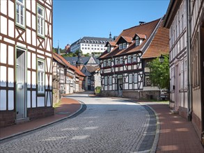 Street with half-timbered houses and cobblestones, behind the castle, Stolberg im Harz,