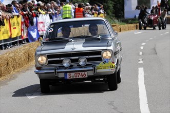 A black vintage racing car at a rally in front of an audience, SOLITUDE REVIVAL 2011, Stuttgart,