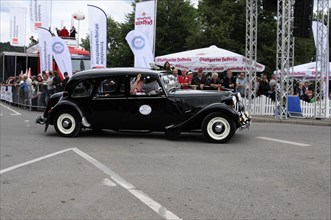 An elegant black and white vintage limousine takes part in a race, SOLITUDE REVIVAL 2011,