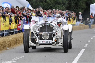 Mercedes-Benz SSK, built in 1928, A white classic racing car with the number 12 drives past a crowd