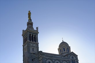 Church of Notre-Dame de la Garde, Marseille, spire of a church with a golden statue against the