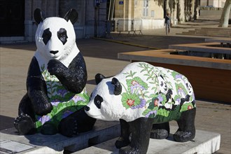 Two panda sculptures on a square, one colourfully painted with floral motifs, Marseille,