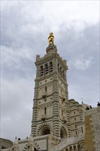 Madonna, Church of Notre-Dame de la Garde, Marseille, The steeple of a historic cathedral with a