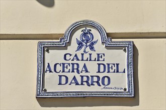 Granada, ceramic tile street sign 'Calle Acera del Darro' on a light-coloured house wall, Granada,
